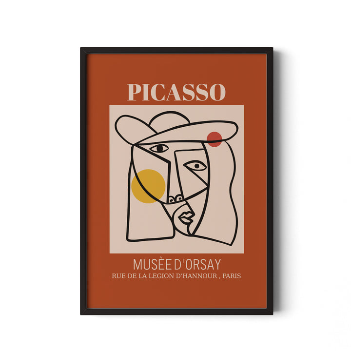 Framed artwork with Picasso face design on a brown background