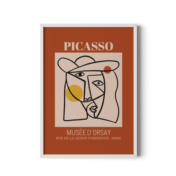 Framed artwork with Picasso face design on a brown background